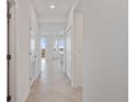 Bright hallway with tile flooring leading to the living area and offering ample closet space at 12180 Wellen Golf St # 302, Venice, FL 34293