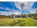 Large backyard with a new wooden fence, mature trees, and a view of the rear of the house at 221 Laurel E Rd, Nokomis, FL 34275