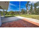 Outdoor patio area featuring both brick and concrete finishes, overlooking a tranquil waterfront at 221 Laurel E Rd, Nokomis, FL 34275