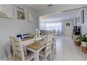 Bright dining room with a neutral color palette and views into the living area at 2412 Grove St, Sarasota, FL 34239