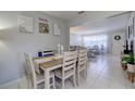 Open-concept dining area with a stylish table and chairs, flowing into the living room at 2412 Grove St, Sarasota, FL 34239
