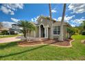 Inviting home with well-maintained landscaping, brick-lined flower beds, and a brick driveway at 27621 Kirkwood Cir, Wesley Chapel, FL 33544