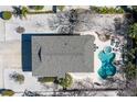 Aerial view of home featuring a roof, pool and spa, patio furniture, and an exterior entirely enveloped in rock at 313 Magnolia Ave, Anna Maria, FL 34216