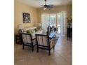 Cozy living room with stylish furniture, tile floors, and a sliding glass door at 3218 45Th E Way, Bradenton, FL 34203