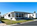 Charming single-story home featuring a screened-in porch and attached carport in a well-maintained community at 3232 Ash Ter, Sarasota, FL 34237