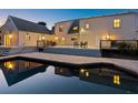 A home back exterior shows a large deck that walks down to the pool and brick patio at 3648 Beneva Oaks Blvd, Sarasota, FL 34238