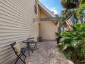 Cozy patio area with outdoor seating, brick pavers, mature trees, and an American flag at 3648 Beneva Oaks Blvd, Sarasota, FL 34238