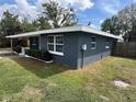 This single-story home has a clean exterior with a manicured lawn, small bushes, and a side carport at 3826 Clover Ln, Sarasota, FL 34233