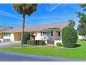 Charming villa with a well-manicured lawn, quaint front patio, and assigned parking space in a serene setting at 390 301 W Blvd # 13A, Bradenton, FL 34205
