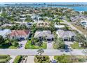 Wide aerial shot showcasing the neighborhood, the lush landscaping, and the architectural styles of the homes at 412 Pheasant Way, Sarasota, FL 34236