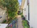 Scenic stone path surrounded by vibrant flowers and foliage, offering a tranquil entrance at 4534 La Jolla Dr, Bradenton, FL 34210