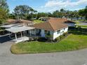 Aerial view of a well-maintained single-story home with a carport and lush green landscaping at 5020 Live Oak Cir, Bradenton, FL 34207