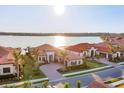 Gorgeous neighborhood with beautiful waterfront views showcasing several homes with terra cotta roofs at 525 Maraviya Blvd, Nokomis, FL 34275