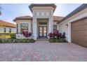 Lovely front entry showcases the home's address, lush landscaping and a gorgeous front door at 525 Maraviya Blvd, Nokomis, FL 34275