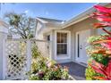 Inviting entrance with a cozy patio area and colorful plants near the front door at 5608 Country Club Way # 5608, Sarasota, FL 34243