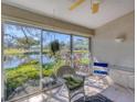 Bright sunroom with tiled floor and large windows overlooking beautiful pond views at 5608 Country Club Way # 5608, Sarasota, FL 34243