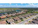 An aerial view of a beautiful community showcasing lake views and lush landscaping at 6070 Mesa Gln, Bradenton, FL 34203