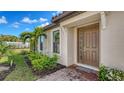 Inviting front door with meticulous landscaping with a palm tree at 6070 Mesa Gln, Bradenton, FL 34203