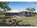 Charming home exterior with a metal roof, a fenced yard and manicured landscaping for privacy and curb appeal at 6510 24Th E Ave, Bradenton, FL 34208