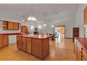 Spacious kitchen featuring an island, tile floors, and seamlessly connected to the dining and living areas at 6510 24Th E Ave, Bradenton, FL 34208