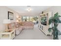 Comfortable living room with plush seating, neutral carpeting, and a large window offering ample natural light and a serene view at 6812 19Th W Ave, Bradenton, FL 34209