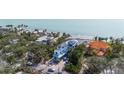 Aerial shot of a modern home close to the beach and with lush greenery at 7324 Point Of Rocks Rd, Sarasota, FL 34242