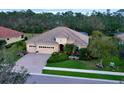 Beautiful one-story home featuring a brick driveway, 3 car garage, landscaping, and tile roof at 8224 Larkspur Cir, Sarasota, FL 34241