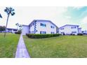 Condo building with green lawn, bushes, sidewalk and street parking at 105 47Th Avenue W Dr # 377, Bradenton, FL 34207