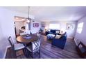 Open-concept living and dining area with gray walls and wood-look floors at 105 47Th Avenue W Dr # 377, Bradenton, FL 34207