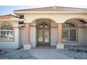 Elegant entryway with a glass double door, arched windows, and decorative columns offering great curb appeal at 108 Mccabe St, Port Charlotte, FL 33953