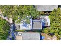 An aerial view of a modern home design with a metal roof and mature trees offering privacy at 1135 Florida Ave, Sarasota, FL 34236