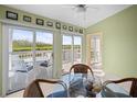 Bright dining area featuring sliding glass doors to a deck overlooking the water and a seating area at 1218 Spoonbill Landings Cir, Bradenton, FL 34209
