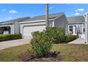 Charming exterior of home features a well-manicured lawn and a two-car garage at 1218 Spoonbill Landings Cir, Bradenton, FL 34209