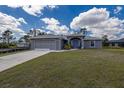 Well maintained exterior and spacious front lawn of this single-story home with attached garage at 1269 Rasp Ct, North Port, FL 34288