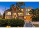 A waterfront property features a private dock and a three-story house with balconies and attached garages at 1364 Point Crisp Rd, Sarasota, FL 34242