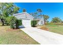 Well-maintained single-story home featuring an attached garage and a neatly landscaped yard at 1761 Shevlin St, North Port, FL 34286