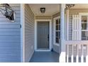 Close-up of the home's entrance, showcasing a classic front door and charming porch details at 1761 Shevlin St, North Port, FL 34286