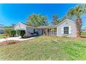 Inviting single-story home with a well-manicured lawn and a welcoming front porch area at 1761 Shevlin St, North Port, FL 34286