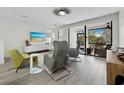 Cozy living room with sleek flooring, modern furniture, and a sliding door to the outdoors at 1900 Harbourside Dr # 102, Longboat Key, FL 34228