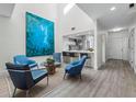 Open-concept living space featuring modern decor, sleek flooring, and a partial view of the kitchen at 1900 Harbourside Dr # 102, Longboat Key, FL 34228