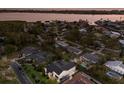 An aerial view showcasing the property's location near the water, mature trees, and neighborhood at 1932 Baywood Ter, Sarasota, FL 34231