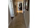 Hallway with gleaming tile floors and neutral walls leads to other rooms in the home at 2422 Wilderness W Blvd, Parrish, FL 34219