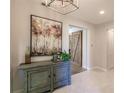 Inviting foyer featuring a stylish sideboard, elegant artwork, and a rustic barn door at 2962 Trustee Ave, Sarasota, FL 34243