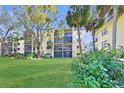 Well-maintained building with a spacious lawn and mature trees in a serene community setting at 315 30Th W Ave # B214, Bradenton, FL 34205