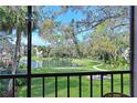 Relaxing view from the screened-in patio overlooking the beautiful pond and lush landscaping at 315 30Th W Ave # B214, Bradenton, FL 34205