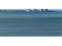 Expansive water view featuring sailboats on the clear blue waters, with buildings faintly visible in the distance at 35 Watergate Dr # 1103, Sarasota, FL 34236