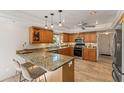 Well-equipped kitchen featuring granite countertops, wooden cabinets, and stainless steel appliances at 3809 21St W Ave, Bradenton, FL 34205