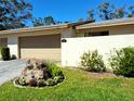 Landscaped front yard with beautiful flowers and lush green grass at 3818 Sun Eagle Ln, Bradenton, FL 34210
