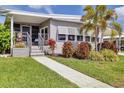 Attractive home with mature landscaping, well-maintained lawn, and covered front porch entrance at 4304 14Th E St, Ellenton, FL 34222