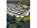 Expansive aerial perspective showcases a dense residential area beside a lake, surrounded by green space at 4527 13Th E St, Ellenton, FL 34222